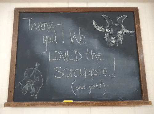 Chalkboard with a thank you message about scrapple and goats, featuring drawings of a goat and a chicken.