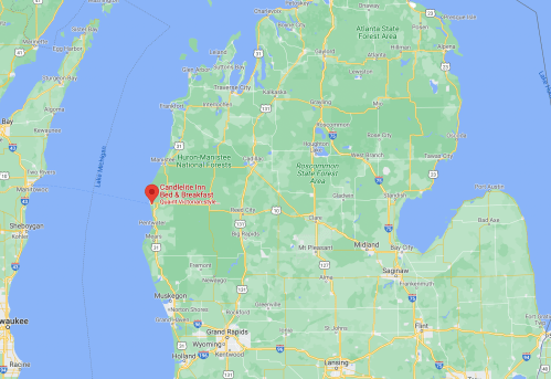 Map showing the location of Candeline Inn Bed & Breakfast in Michigan, near Lake Michigan and surrounded by forests.