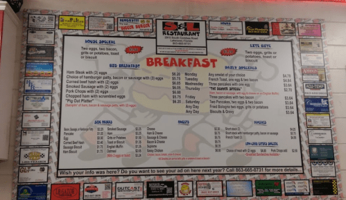 Menu board at a restaurant featuring breakfast options, daily specials, and house specials with various prices.