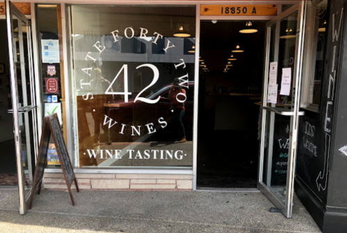 Entrance of State Forty Two Wines, featuring a sign for wine tasting and an inviting atmosphere.