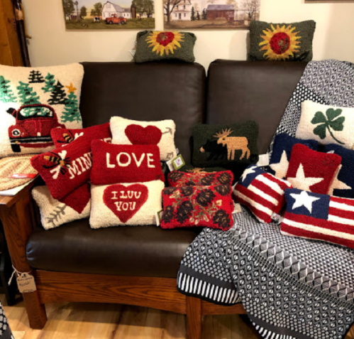 A cozy sofa adorned with colorful decorative pillows and a patterned throw blanket.