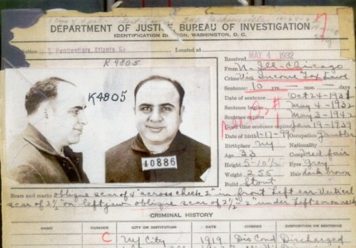 Mugshot and identification card of Al Capone, detailing his criminal history and personal information.