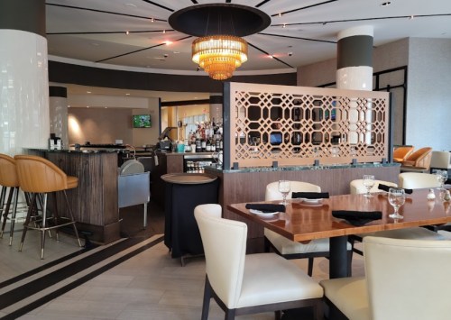 Modern restaurant interior featuring elegant seating, a stylish bar, and decorative lighting.