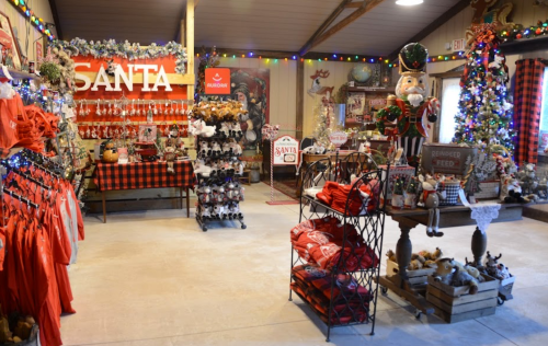 A festive shop decorated for Christmas, featuring Santa-themed items, ornaments, and holiday decorations.