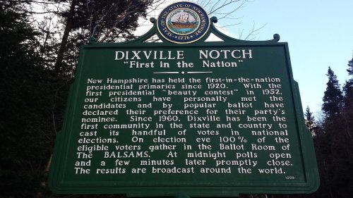 Historical marker for Dixville Notch, NH, noting its role in presidential primaries and voting traditions since 1960.