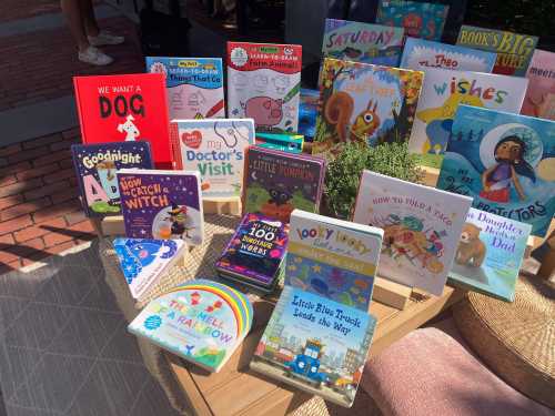 A colorful display of children's books on a table, featuring titles about dogs, doctors, and bedtime stories.