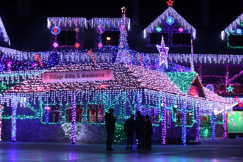 A brightly lit building adorned with colorful holiday lights, creating a festive atmosphere at night.