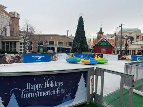 An ice skating rink decorated for the holidays, featuring colorful inflatable tubes and a festive backdrop.