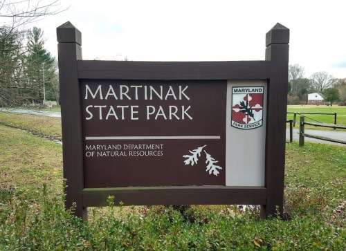 Sign for Martinak State Park, featuring the Maryland Department of Natural Resources logo and park information.