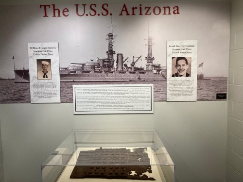 Exhibit featuring the U.S.S. Arizona, with portraits of sailors William T. Halsey and Frank W. Henderson.
