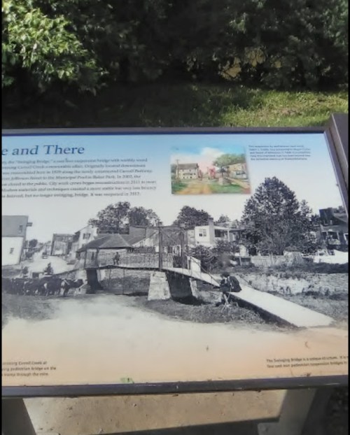 Historical sign featuring a bridge, with images of past and present views of the surrounding area.