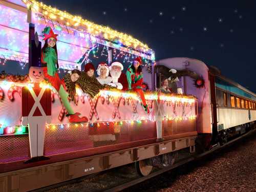 A festive train decorated with lights, featuring Santa, elves, and holiday decorations against a starry night sky.