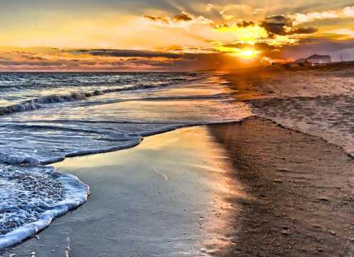 A serene beach at sunset, with gentle waves lapping at the shore and vibrant colors in the sky.