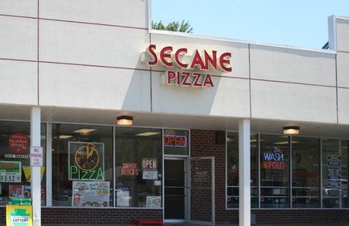 Exterior of Secane Pizza with a bright sign, open windows, and a welcoming atmosphere.