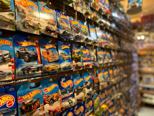 A wall of Hot Wheels toy cars displayed in packaging, showcasing a variety of colorful models.