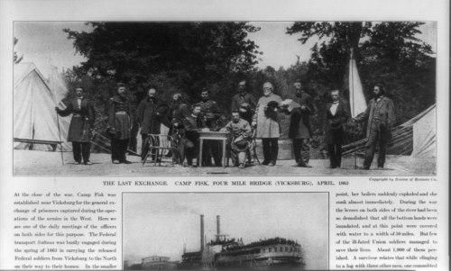 Black and white photo of soldiers and officials at Camp Fisk, Vicksburg, April 1863, with tents and a riverboat in the background.