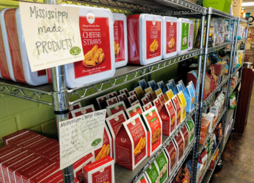 Shelves stocked with various Mississippi-made products, including cheese straws in colorful packaging.