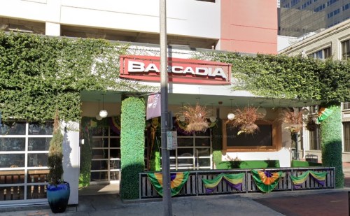 Exterior of a restaurant named "Bacadia," adorned with greenery and festive decorations.