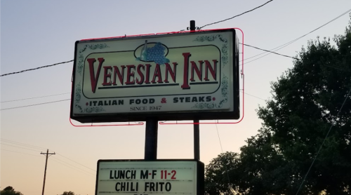 Sign for Venesian Inn, featuring Italian food and steaks, with lunch hours and a special for Chili Frito.