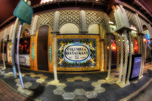 Colorful exterior of the Columbia Restaurant, featuring decorative tiles and columns, established in 1905.