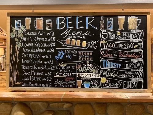 Chalkboard beer menu featuring various craft beers, specials for each day, and a colorful design.