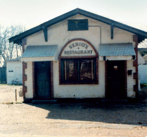 A vintage building with a sign reading "Serio's Restaurant," featuring awnings and a rustic exterior.