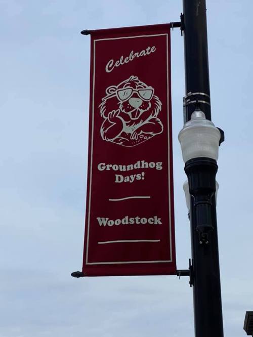 Red banner featuring a cartoon groundhog, promoting "Celebrate Groundhog Days! Woodstock."