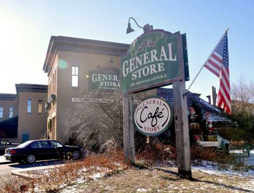 A general store in Minnetonka with a café sign and an American flag, surrounded by winter scenery.