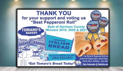 A sign thanking supporters for voting Tomaro's Bakery "Best Pepperoni Roll" with contact info and promotional details.