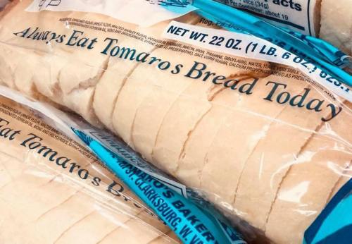Sliced bread loaves in packaging with the text "Always Eat Tomaro's Bread Today" prominently displayed.