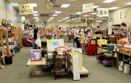 A spacious craft store filled with art supplies, DIY kits, and colorful displays, with shoppers browsing the aisles.