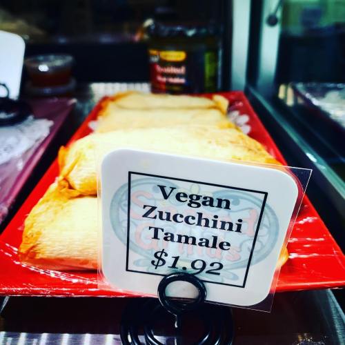 A display of vegan zucchini tamales with a price tag of $1.92.