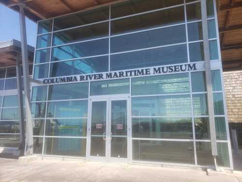 Exterior view of the Columbia River Maritime Museum, featuring large glass windows and a modern design.