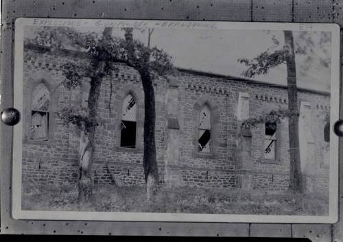 Black and white photo of a stone building with broken windows, surrounded by trees, labeled "Explosions - Gunpowder - Brandywine."