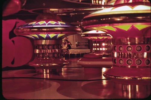 Colorful, retro-style light fixtures with geometric patterns in a vibrant, abstract interior setting.