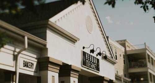 Exterior of a building featuring a sign for "Hebron Market" and a nearby "Bakery" storefront.