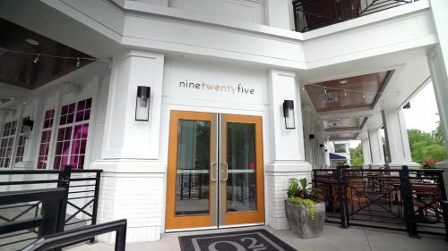 Exterior view of a restaurant named "ninety two five," featuring a welcoming entrance and outdoor seating area.