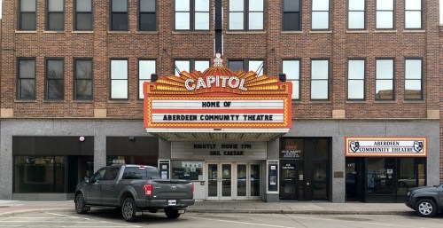 The Capitol Theatre marquee displays "Home of Aberdeen Community Theatre" in a historic brick building.