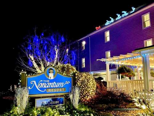 A brightly lit resort sign at night, surrounded by festive holiday decorations and lights.