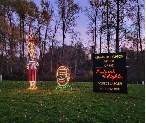 Colorful holiday lights display featuring a nutcracker and a sign honoring Kerwin Doughton, founder of the Festival of Lights.