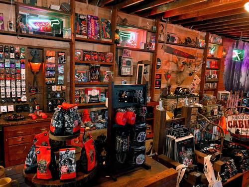 A vibrant shop interior filled with various merchandise, including clothing, accessories, and neon signs.