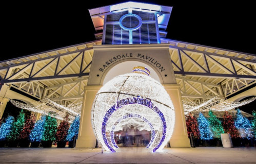 A festive display at Barksdale Pavilion featuring colorful lights and a large ornament-shaped structure.