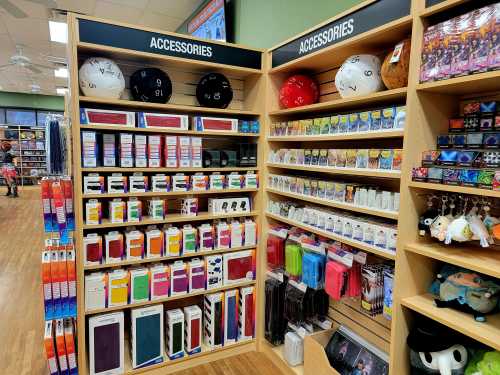 A store display featuring shelves of gaming accessories, including dice, card sleeves, and various gaming items.