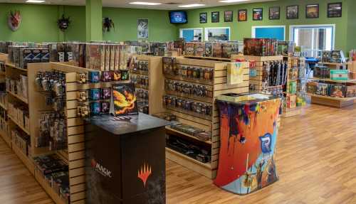 A brightly lit game store interior with shelves filled with board games and card games, featuring colorful displays.