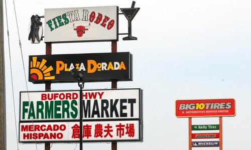 A collection of colorful business signs, including Fiesta Rodeo, Plaza Dorada, and Buford Highway Farmers Market.