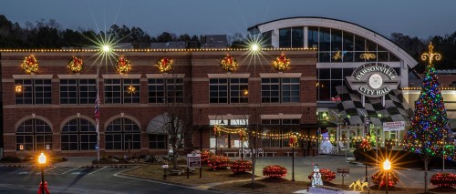 Jacksonville City Hall decorated for the holidays, featuring lights, wreaths, and a Christmas tree in the foreground.