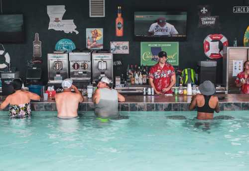 People enjoying drinks at a poolside bar, with a bartender serving in a tropical setting.