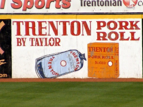Sign featuring "Trenton Pork Roll" by Taylor, with illustrations of pork roll packages in blue and orange.