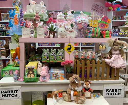 A colorful display of stuffed bunnies, toys, and decorations in a shop, featuring a "Rabbit Hutch" sign.