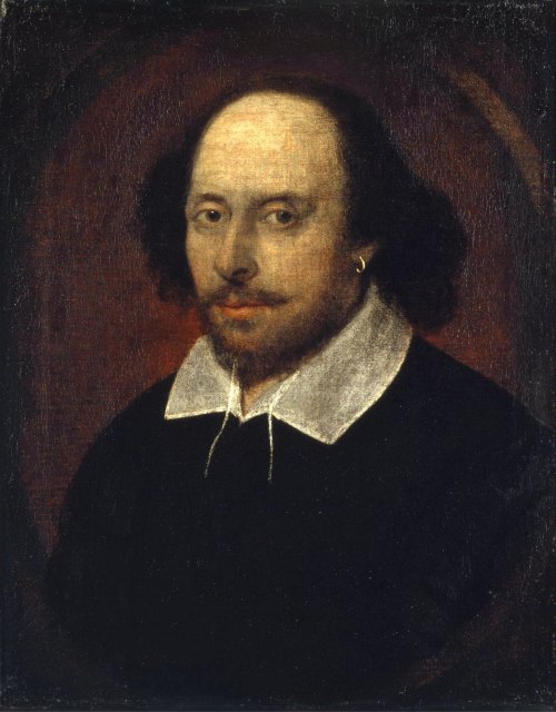 Portrait of a man with curly hair, wearing a black outfit and white collar, set against a dark background.